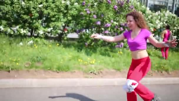 Vrouw rolschaatsen in park — Stockvideo