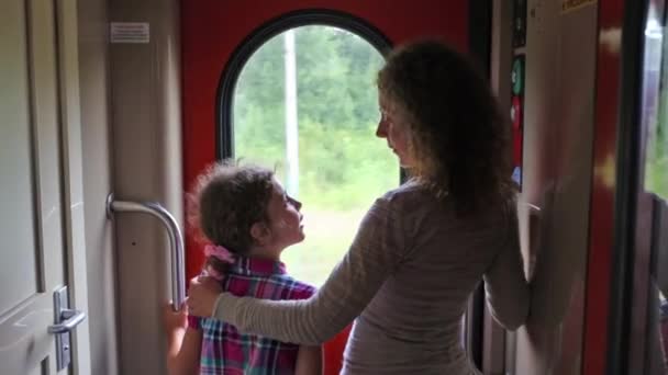 Girl and mother look at window of train. — Stock Video