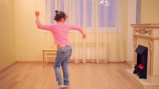 Flickan dansar i nya rum med öppen spis — Stockvideo