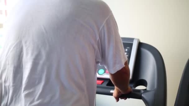 Back of man training on treadmill — Stock Video