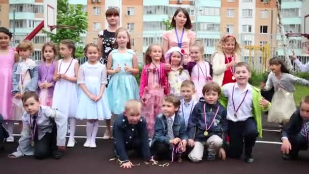 Children and women standing on playground — Stock Video