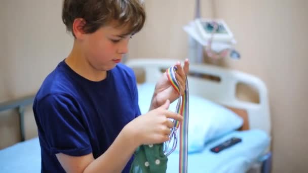 Boy looks at cap for electroencephalography — Stock Video
