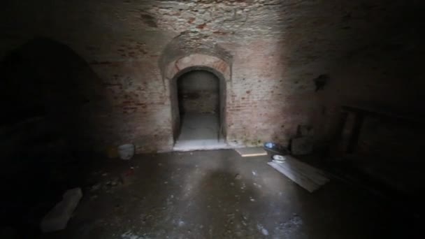 Indoor view of dark basement with brick walls — Stock Video