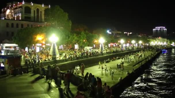 People walk on embankment at night In Crimea — Stock Video