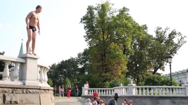 Uomo si tuffa per incanalare su Manezhnaya Square — Video Stock