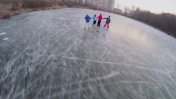Четверо детей катаются на коньках — стоковое видео