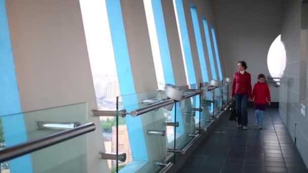 Mother with girl going near windows — Stock Video