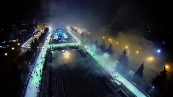 People skating by ice rink with fireworks — Stock Video