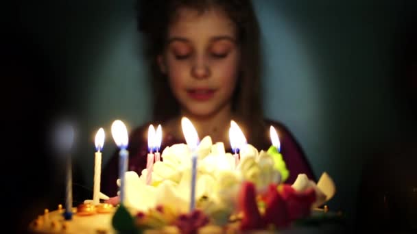 Girl makes wish and blowing candles — Stock Video