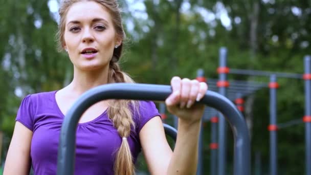 Girl stands on outdoor sports ground — Stock Video