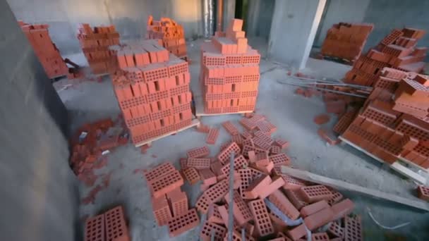 Stacks of red bricks inside — Stock Video