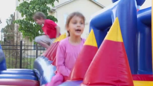 Little girl at inflatable playground — Stock Video