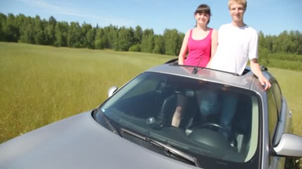 Guy with girl stand in roof aperture — Stock Video