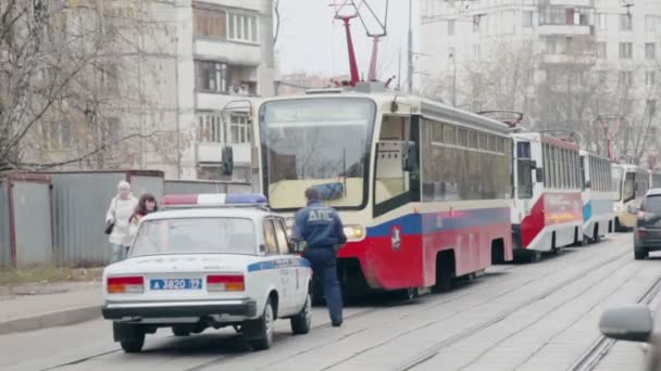 Policeman walk on street with tramways — Stock Video