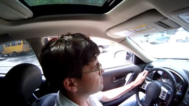 Man sits in salon of car — Stock Video