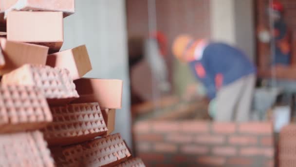 Stack of bricks and few workers — Stock Video