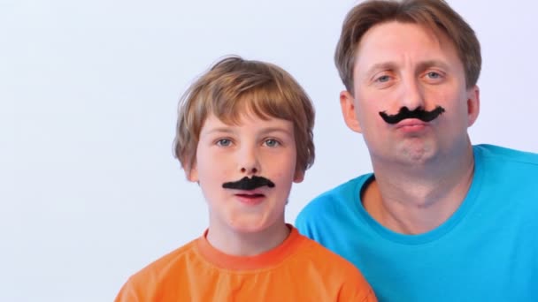 Father and son with false moustaches — Stock Video