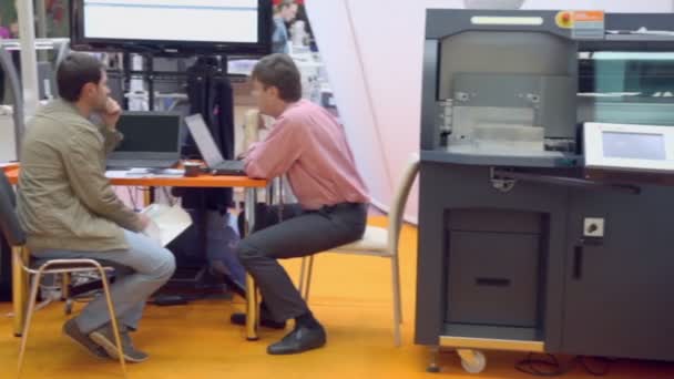 Zwei Männer sitzen in der Nähe des Computers — Stockvideo