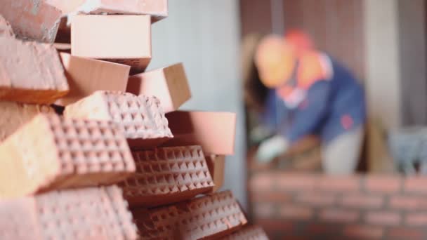 Pile of bricks and few workers — Stock Video