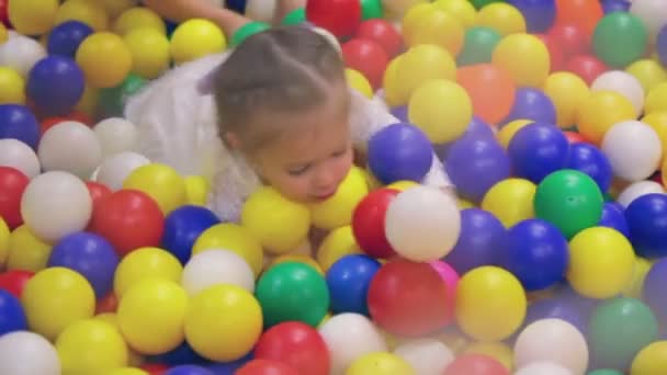 Little girl in plastic spheres — Stock Video