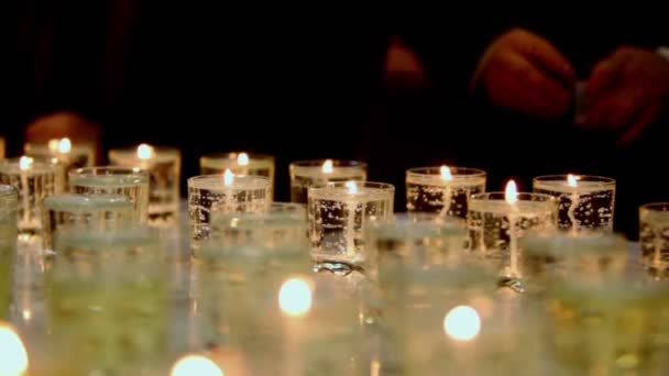 Many candles burn in glasses — Stock Video