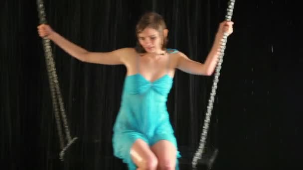 Sexy girl in blue dress sways at swing — Stock Video