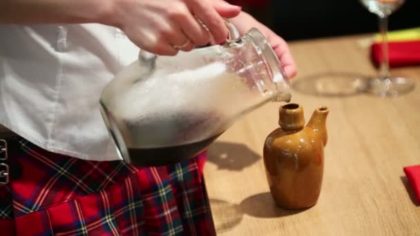 Girl pours drink to bottle — Stock Video