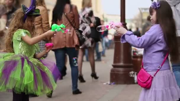 Little girls blow soap bubbles — Stock Video