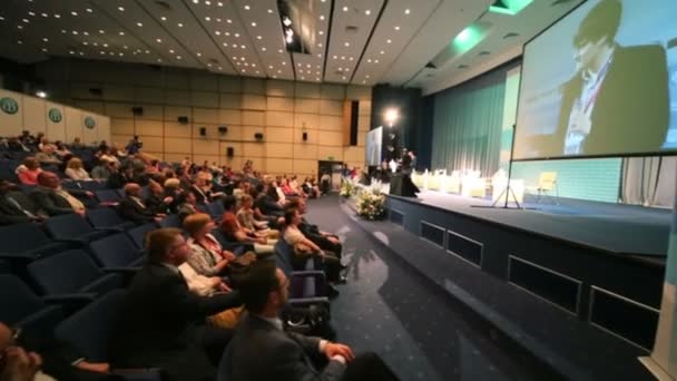 Mensen zitten in de hal op internationale conferentie — Stockvideo