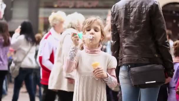 Girl inflates bubbles during celebration — Stock Video