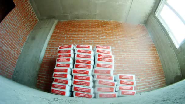 Migrant workers putting plaster bags — Stock Video