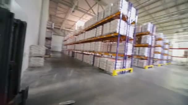 Man rides on loader at Caparol factory — Stock Video