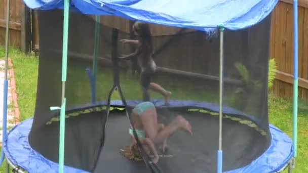 Two girls having fun on trampoline — Stock Video