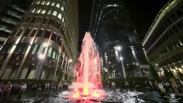 La gente se sienta cerca de la fuente en la plaza — Vídeos de Stock