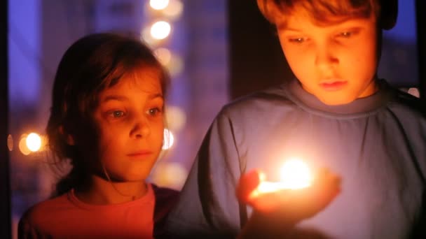 Little boy and girl with candle — Stock Video