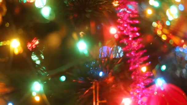 Hand putting decoration on christmas tree — Stock Video