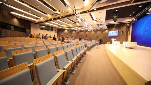 Personnes entrant dans la salle de conférence principale — Video