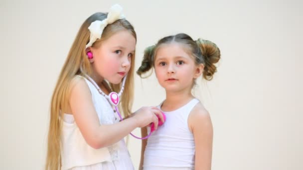 两个可爱的女孩，用听诊器 — 图库视频影像