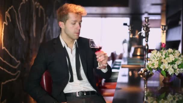 Блондин пьет вино. — стоковое видео