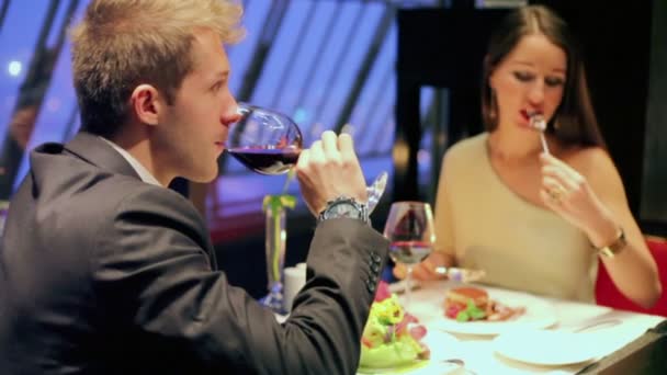 Man drinks red wine with woman — Stock Video