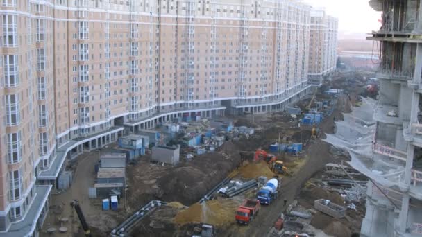 Long building near construction site — Stock Video