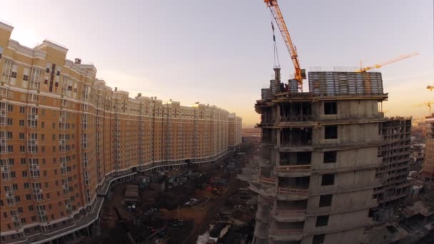 Long building near construction site — Stock Video