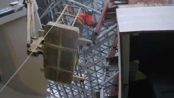 Welder on cradle on airport construction — Stock Video