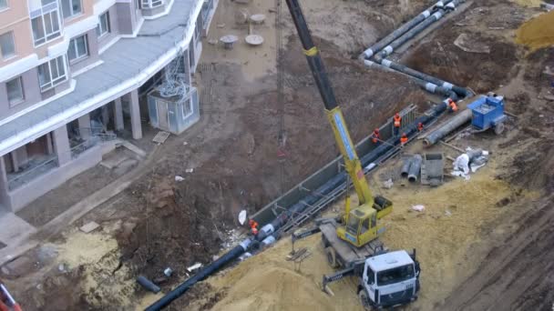 Workers setting tubes in ground — Stock Video