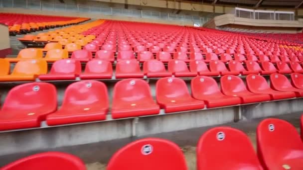 Rows of red and orange plastic seats — Stock Video