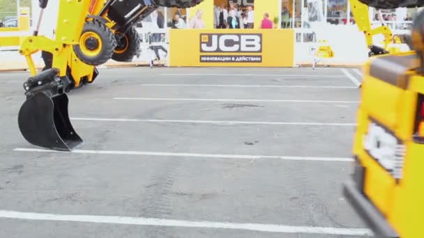 Paseos en cargador cerca de dos excavadoras JCB — Vídeo de stock