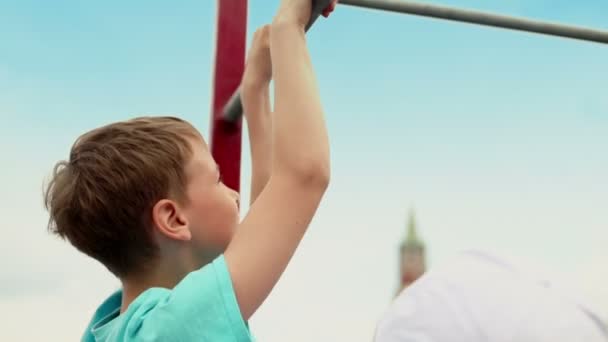 Young boy does chin-ups — Stock Video