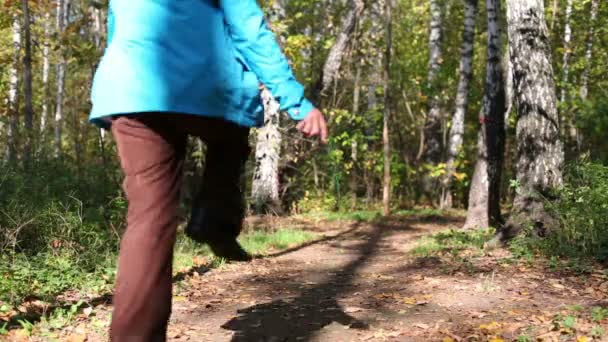 Boy running away through forest — Stock Video