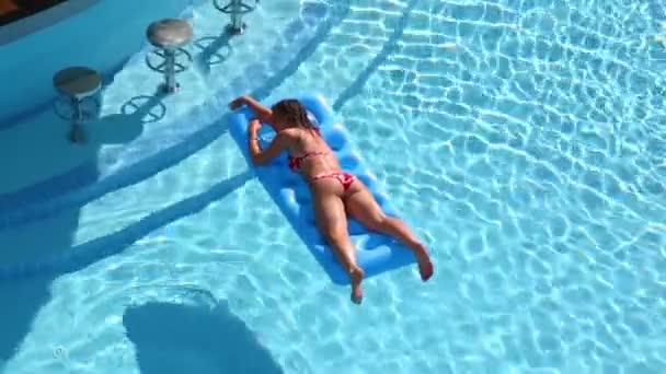 Young girl in swimsuit on air mattress — Stock Video