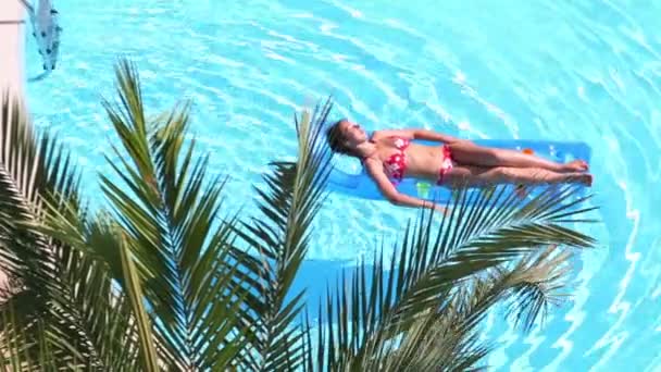 Pretty woman in swimsuit on air mattress — Stock Video